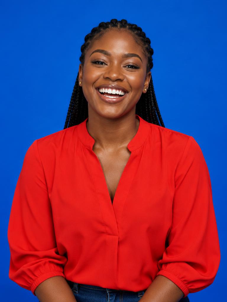 A smiling young Nigerian creative in a bright red blouse